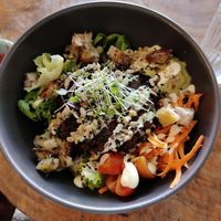 Bowl with hamburger on top at Apuro Vegan Bar in Porto