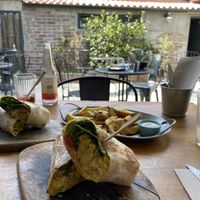 Lazy burrito with fries and a doggy burrito in the back  at Apuro Vegan Bar in Porto