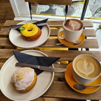 Vegan mango doughnut; hot chocolate with oat milk; vegan coconut & mango doughnut; latte with oat milk at Perk Cafe in Inverness