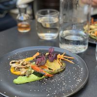 “From Our Garden” first plate. Carrot and asparagus purées with shiitake mushrooms, carrots, asparagus, kale chip. at L'Orygine in Quebec