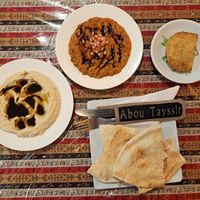 Flat bread, pomegranate hummus, muhammara, borak. at Abou Tayssir in Tangier