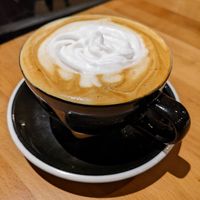 Hazelnut oat milk latte with coconut whip at Snakes & Lattes - Bloor St in Toronto