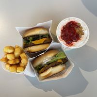 Two cheeseburgers, fries and a strawberry cheesecake shake   at Next Level Burger - Austin in Austin