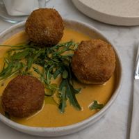 Arancini bacon v.egg, hollandaise, herb oil at Avit in Athens