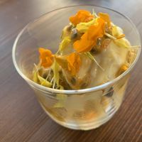 Homemade coconut ice cream (made with dry ice!) infused with pineapple and served with passion fruit and edible flowers... we felt like we were back in Hawaii!  at Avit in Athens