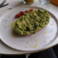 Full avocado toast with grilled tomatoes at Daily Poison in Vilnius