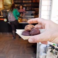 My sweets with store in background at COCO Vegan Chocolate in Tel Aviv