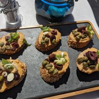 Bruschetta: Hummus | Hummus, olives, onion, capers at Galini Cafe in Santorini