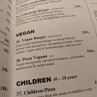Vegan section of the menu contains a burger and a pizza (May 2019), at Café Cathedral in Oslo