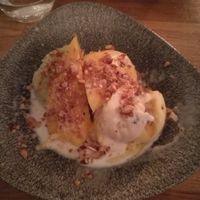 Sticky rice with mango, sorbet, coconut sauce and caramelized nuts. at Ihsiri in Lund