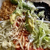 Enchiladas smothered in red and green sauce with all the fixings.  We chose seitan and we chose well! at Ole Ole Burrito Express in Oakland