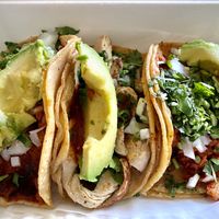 Three tacos side by side. Soyrizo, chik’n, and seitan, (top to bottom).  All come with avocado and side salsas.  So good! at Ole Ole Burrito Express in Oakland