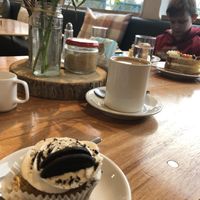 Oreo cupcake, Earl Grey soya milk tea and a Skittles cake in the background 💚 at The Ark in Northampton