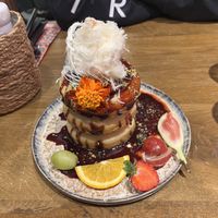 Classic stacks. Made with date syrup, fruit, sesame cotton candy and pistachios   at Mr. Stacks in Amsterdam