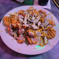 Vegan potato nachos (waffle fries, chick'n strips, melted cheeze, and vegan ranch dressing) at Big League Brews in Taylor