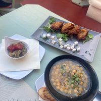 Chickpea stew, tomato fritters with vegan cheese and Smokey aubergine dip  at Karma in Santorini