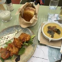 Tomatokeftedes fritters, fresh homemade bread, fava/yellow pea dip with caramelized onions  at Karma in Santorini