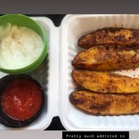 The beautiful potato wedges, garlic sauce & red pepper sauce at Koshary Corner in Clarksville