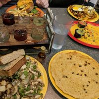 Mimosa flight and a vegan breakfast ? vegan scarmble with toast and home fries, a single chocolate chip pancake and vegan nachos for the table at The Friendly Toast in Burlington