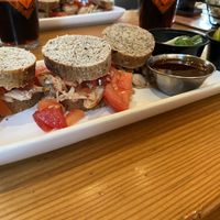 Jackfruit sliders on spent grain bread with tomatoes, jalapeños, pickles, and pickled onions at Voyageur Brewing in Grand Marais
