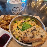 Veggie and Pesto Fritatta: open face omelet (Just Egg) with garlic, onion, bell pepper, mushrooms, spinach, sweet and sour tomato jam, and Pesto, served with herb-grilled sourdough at Breakfast Republic - East Village in San Diego