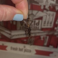Hairball baked into pizza toppings 🤢  at Julien's in Millbrook