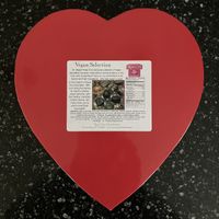 Vegan Silver Embossed Heart - 29 pc (16 oz). Includes includes soft creams, crunchy hazelnut selections, brasero and hazelnut ganaches, marzipan, cordial cherries, & more. at Rose City Chocolatier in Martinsburg