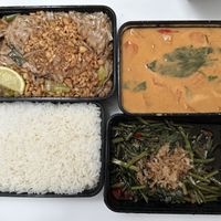 Takeout containers with rice, vegan red curry, fried noodles with tofu (without egg), morning glory  at Wokshop - Kgs Nytorv in Copenhagen