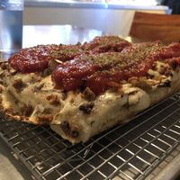Custom detroit pizza with vegan sausages, vegan cheese, mushrooms and tomato sauce at Brigade Pizzeria in Montreal