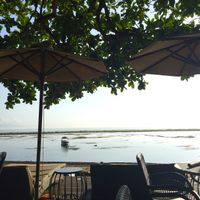 Outdoor seating at Kayumanis Seaside in Sanur