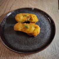 Amuse bouche, fried courgette flowers stuffed with tofu-courgette cream at Bonboon in Amsterdam