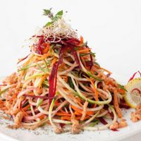 Raw colorful spaghetti with dried tomato sauce at Vegehop in Zagreb