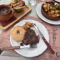 Bean stew, corn bread and pickled vegetables and a side of fried potatoes with dill  at Gruzie in Prague