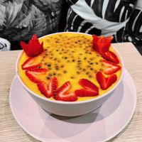 Mango smoothie bowl with passion fruit and strawberries on top at Eat Greens Cafe in Phuket