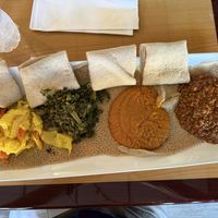 L-to-R: cabbage, kale, chickpeas, red lentils; all served on injera   at Zoma Ethiopian in Cleveland