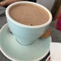 Vegan gluten free hot chocolate (soya milk) and the biscuit is VGF too!   at Teacup Tearoom in Mevagissey
