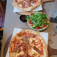 Tomato Base, Vegan Mozzarella, Pizzarami Vegan Sausage, Chillies and Red Onion, Sweet Chilli Dip, Side Salad, Tomato Base, and Vegan Mozzarella, Vegan Bacon, Chillies and Maple Syr at Hangin' Pizzeria in Betws-y-coed