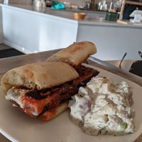 Eggplant Parm with dill potato salad side at Strong Hearts in Syracuse