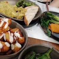 Patatas bravas, lentil dahl, grilled onions, pimientos del padrón at EDO in Belfast