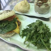 Side biscuit with herbed tempeh gravy and a Sprouted buns sandwich on everything bagel.  at Honey B's in Frankenmuth