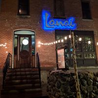 The outside of the restaurant, lit up at night at Lanai in Rochester