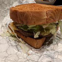 Impossible burger on cosmic toast buns, lettuce, tomato, slaw, asteroid sauce with a vegan swiss cheese slice. at Walt Disney World - Cosmic Ray's Starlight Cafe in Lake Buena Vista