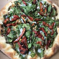 "Julie's Favorite Pizza"  Love the charred spinach (instead of sloppy overcooked sauteed spinach like most places).  Needs bigger tempeh pieces, but was still GREAT. at Julie Goes Green in Los Angeles