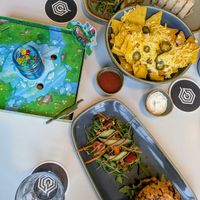 Loaded nachos, the chickpea bagel and a wrap at The Treehouse Board Game Cafe in Sheffield