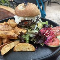 Green Goddess lentil,  oat , poblano/green peppers, pumpkin, onion and herbs burger with avocado, cucumber, pumpkin, pumpkin and sunflower seeds. Added seed cheese. Potato wedges  at Arte Sano in Holbox