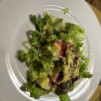 Partially eaten salad with melonn  at Bibliothe in Rome