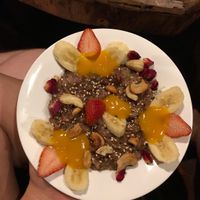 Brown rice pudding with mango purée, fruits and nuts  at Joy in Candolim