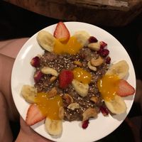 Vegan brown rice pudding with mango purée, fruits and nuts  at Joy in Candolim