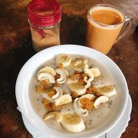 Porridge with oats, chia seeds, cashew nuts, banana and raisins 😋😋😋 at Joy in Candolim