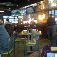 The dining area has a mix of different style chairs and tables. There are also booths. It has a fun & cheerful atmosphere. at Beertown Public House in Burlington